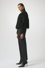Load image into Gallery viewer, Woman wearing a black faux fur boxy jacket, black studded jeans and high heeled boots against a white background.
