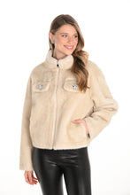 Load image into Gallery viewer, Woman wearing a champagne faux fur jacket and black leather pants against a white background. 
