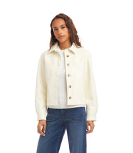 Load image into Gallery viewer, Woman wearing an off-white jacket over a white top and blue jeans against a white background.
