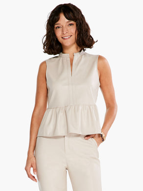 Made from vegan leather, it's easy to elevate any look with this elegant top in tasteful beige. This sleeveless silhouette is designed with ruching details around the neck and at the slightly flared waist, giving it a feminine look and shape. A split neck makes it easy to pull on. Pairs with everything from denim to our matching FRAIDA FAUX LEATHER STRAIGHT LEG TROUSER - NIC & ZOE.  Color- Cobblestone; Light beige. Lightweight. Regular fit. Split neck. Sleeveless. Sits at hip.