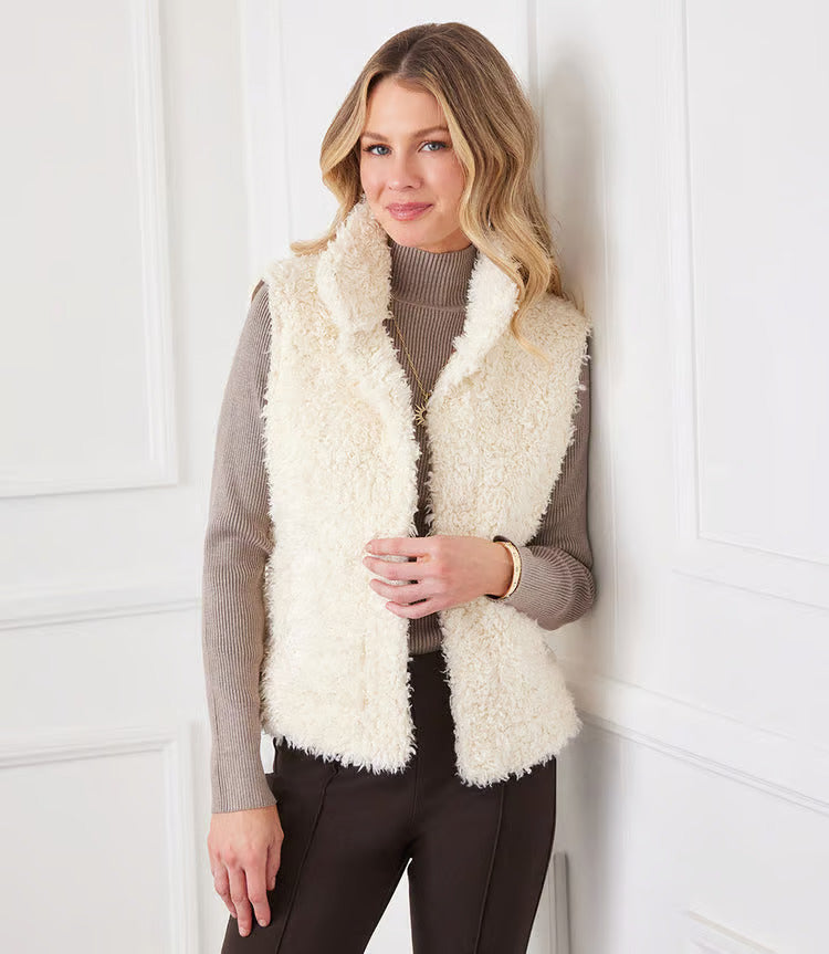 Indulge in luxury with our Faux Shearling Vest. Made from plush, faux shearling, this vest provides warmth and style all season long. Its versatile design enhances any outfit, from dresses to turtlenecks and jeans.