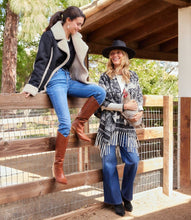 Load image into Gallery viewer, Two women sitting on a wooden fence outdoors, wearing stylish clothing.
