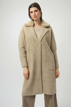Load image into Gallery viewer, Woman wearing a long warm taupe coat with detachable faux fur and brooch and taupe jeans against a white background.

