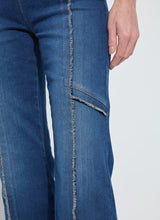 Load image into Gallery viewer, Close-up of fringe blue jeans with a white background.
