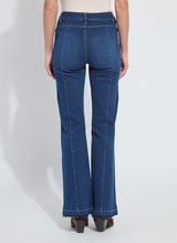Load image into Gallery viewer, Model wearing blue jeans and brown suede boots against a white background.
