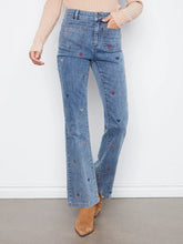 Load image into Gallery viewer, Person wearing blue jeans with heart patterns against a white background
