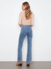 Load image into Gallery viewer, A woman is shown from the back wearing a beige ribbed long-sleeve top and light blue high-waisted flare jeans, standing against a white wall.
