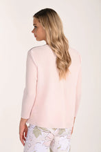 Load image into Gallery viewer, Woman wearing a light pink cardigan and floral pants on a white background.
