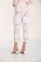 Load image into Gallery viewer, Woman wearing a light pink top and blush floral crop pants and silver sandals on a white background.
