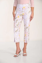 Load image into Gallery viewer, Woman wearing a light pink top and blush floral crop pants and silver sandals on a white background.
