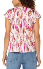 Load image into Gallery viewer, Elevate your wardrobe with the Liverpool Los Angeles Flutter Sleeve Button Front Knit Top! Featuring a romantic V-neck, flutter sleeves, and exclusive vibrant pink painted ikat print, this top blends effortless charm with everyday versatility. Perfect for pairing with jeans or shorts for a chic, season-to-season look.
