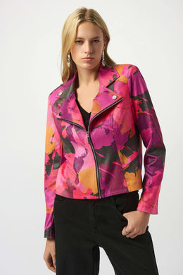Woman modeling a pink, purple and golden yellow moto jacket and black jeans against a white background.