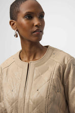 Load image into Gallery viewer, Woman wearing a warm taupe quilted jacket with silver embellishments against a white background.
