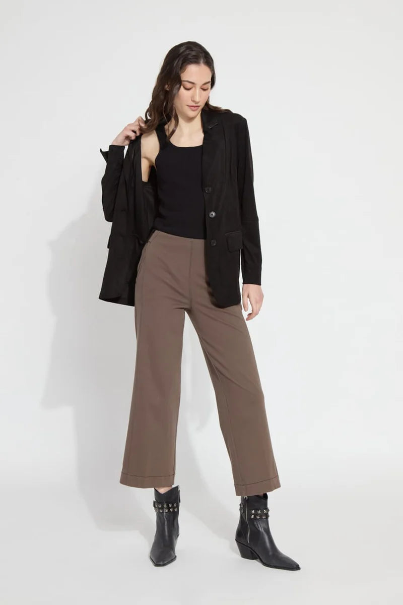 Our Franca Seamed Wide Leg Crop in 4-way stretch Knit Denim features a concealed patented waistband, tricot-lined pockets for a smooth silhouette, contrast-color topstitching, and vegan suede belt loops. Designed to fit snugly at the waist and skim the hips, it flares into a wide-legged crop. With a back yoke and garment dye for added softness, it includes vertical seams running from the pocket to the hem, enhancing the appearance of slimmer hips.