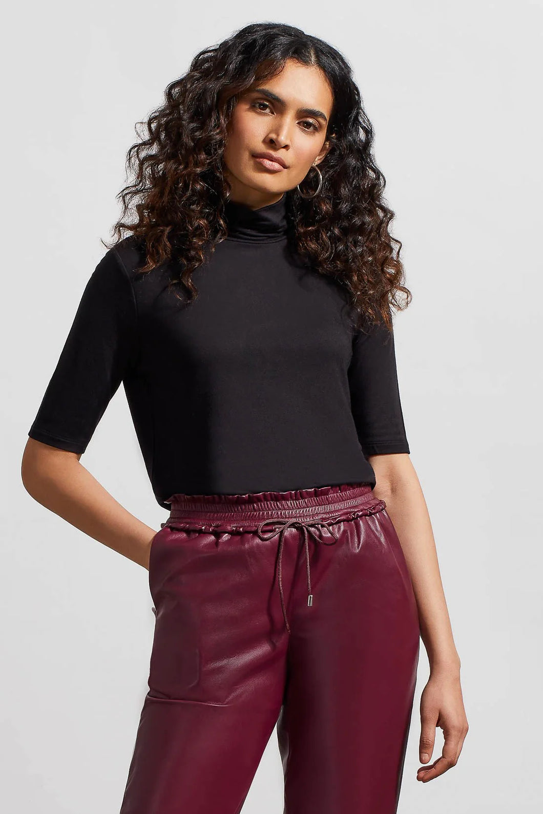 This top stands out for its versatile style and comfort. The soft, stretchy French terry knit fabric, combined with a mock neckline and elbow-length sleeves, provides perfect details. It's ideal for wearing on its own or for layering under a preferred blazer or jacket.