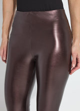 Load image into Gallery viewer, Constructed from Lightweight Vegan Leather in a metallic, Diffused Copper finish, the Freya Legging is garment washed to achieve 3D texture and softness. Boasting a patented concealed waistband and sans side seams, the Freya offers a snug, yet flexible fit. With 4-way stretch for comfort, it pairs perfectly with a white blouse, cropped vegan leather jacket, and black mules.
