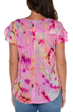 Load image into Gallery viewer, This woven tee is the perfect blouse to take you from season to season. Featuring a shirred back, v-neckline, and flirty petal sleeves, this top is a standout in vibrant colors.! Drawstring details at the shoulders create a fun and modern look. 
