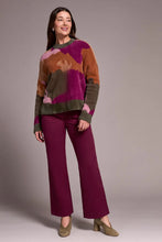 Load image into Gallery viewer, Woman wearing a colorful abstract print sweater, purple pants and olive suede heel shoes against a plain background.
