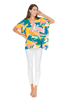 Pops of brilliant color in a geo abstract puzzle print come together to create a spectacular spring/summer top by Jade Melody Tam.  A flattering fit, this short sleeve top has additional fabric stitched on each side that drapes nicely, while the top has a V-neck design, allowing you to showcase your favorite necklace.  Gorgeous when paired with your favorite white bottoms.  Colors - Bright pink,, yellow, blue, green, mint, coral and white. V-Neck. Pullover.