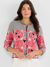 Load image into Gallery viewer, Woman wearing a stripe and floral patterned cardigan and white pants against a white background.

