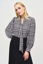 Load image into Gallery viewer, Crafted from exquisite georgette material, this black and white plaid top with dots of color, exudes elegance and sophistication, making it the perfect addition to any outfit. The V-neckline is adorned with a charming scarf tied at the center, adding a touch of refinement to this modern piece. The long puff sleeves with cuffs add a playful touch, while exuding confidence in this delightful top.
