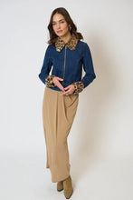 Load image into Gallery viewer, Woman wearing a blue denim jacket with leopard print collar and cuffs, beige pants, and tan boots against a white background.
