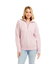 Load image into Gallery viewer, Woman wearing a pink half-zip sweater and light blue jeans against a white background.
