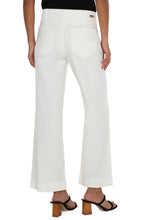 Load image into Gallery viewer, Experience ultimate comfort and style with our Hannah Flare Eco Jean in Soft White. Carefully crafted from premium soft denim, these jeans provide a luxurious and cozy feel. The classic flare silhouette adds a vintage touch to your outfit, while the utility stitched pockets combine fashion and function.
