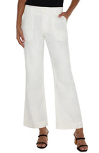 Load image into Gallery viewer, Experience ultimate comfort and style with our Hannah Flare Eco Jean in Soft White. Carefully crafted from premium soft denim, these jeans provide a luxurious and cozy feel. The classic flare silhouette adds a vintage touch to your outfit, while the utility stitched pockets combine fashion and function.
