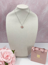 Load image into Gallery viewer, This unique piece is a valuable find. The delicate vintage CC heart zipper pull, adorned with dazzling clear crystals, adds a touch of charm in soft pink. Exude radiance and make a statement when you wear this gorgeous piece.
