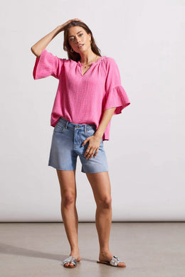 This lovely blouse is made of crinkled gauze cotton, which gives it a light and elegant touch. It features a notch neck that you can pop over, elbow-length raglan sleeves, and bell-shaped cuffs that add some playful charm.