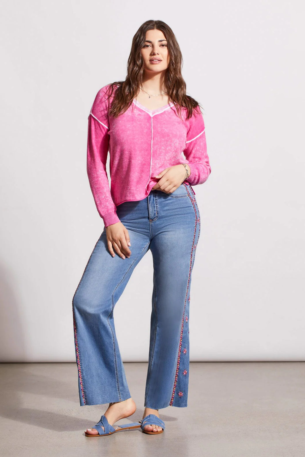 One of our top sellers, this light and adaptable V-neck sweater is a perfect choice for casual, trendy fashion.  Our gorgeous sweater offers a bright pop of pink color, pop-over design and long sleeves with drop shoulders, an exposed center seam, and a high-low hem with side-slit details.  Color - Hi pink. Pop-over v-neck. Long sleeve with drop shoulder Exposed center seam; high-low hem with side slits Special reverse bleach print Fabric - 100% Cotton.