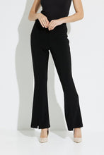 Load image into Gallery viewer, Add a touch of flare with a split front hem and you have the most fashionable pair of black pants that make a sleek, modern statement.  This Joseph Ribkoff high rise flare leg pant has a flattering fit and wider cut, which lengthens your leg for a truly polished look.  Color- Black. Elastic waist. High rise. Flattering fit. Long flared leg.
