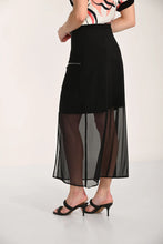 Load image into Gallery viewer, Model wearing a floral top, long black skirt with mesh and black sandals on a white background.

