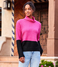 Load image into Gallery viewer, This cozy sweater helps keep out chilly weather and looks great with its hot pink and black colorblock design. Contrasting hem and sleeve detail create a sophisticated look. Color- Hot pink and black. Colorblock on hem and sleeves. Turtleneck. Ribbed detail. Fabric- 53% Recycled Polyester. 38% Acrylic. 7% Wool. 2% Spandex. Care- Dry clean.
