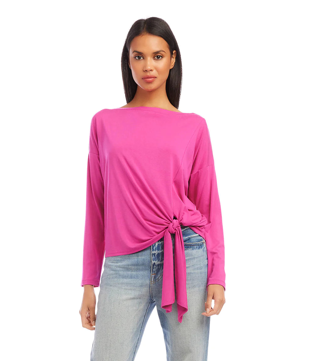 A flattering silhouette is created with the cinching at the waist of this knit top, which also includes a boatneck, drop shoulder sleeves, and an on-trend tie-front.  Color- Hot pink. Tie front. Boatneck. Long sleeve. Pick-up hem. Fabric - Jersey knit: 90% Rayon, 10% Spandex