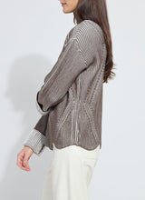 Load image into Gallery viewer, Person wearing a brown and white striped sweater and white pants against a plain background.
