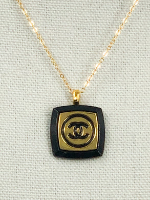 The recognizable gold and black Chanel emblem speaks to the timeless elegance and luxury of this iconic design. This unique Ina Iconic Black and Gold Vintage Coco Chanel Button Necklace is a remarkable addition to any ensemble, featuring a rare design and rich historical value. Experience a unique and eye-catching look with this one-of-a-kind button necklace.