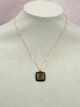 Load image into Gallery viewer, The recognizable gold and black Chanel emblem speaks to the timeless elegance and luxury of this iconic design. This unique Ina Iconic Black and Gold Vintage Coco Chanel Button Necklace is a remarkable addition to any ensemble, featuring a rare design and rich historical value. Experience a unique and eye-catching look with this one-of-a-kind button necklace.
