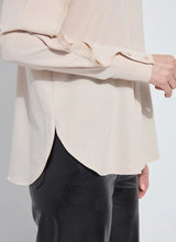 Load image into Gallery viewer, Model wearing a rose petal colored blouse with ruffle detailing and black pants against a white background.
