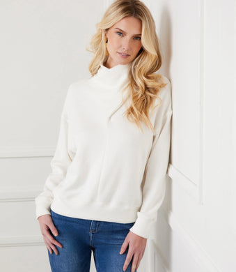 Discover the seamless blend of style and comfort with our Faux Wrap Turtleneck. Crafted from a plush sweater knit, this top offers a relaxed fit that complements every figure. Elevate your closet collection and enjoy all-day warmth and coziness!