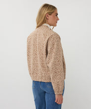 Load image into Gallery viewer, Woman wearing a beige textured bomber jacket and blue jeans against a white background.
