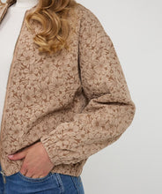 Load image into Gallery viewer, Beige floral-patterned jacket worn by a person against a white background.
