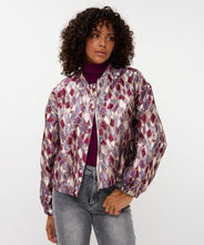 Load image into Gallery viewer, Woman wearing a mosaic patterned jacket and jeans against a white background.
