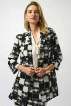 Load image into Gallery viewer, Woman wearing a black and white checkered blazer over a white blouse and matching skirt against a white background.
