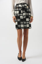 Load image into Gallery viewer, Woman modeling a white blouse and black and white plaid skirt and black heels against a white background.
