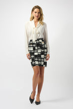 Load image into Gallery viewer, Woman modeling a white blouse and black and white plaid skirt and black heels against a white background.
