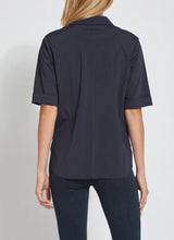 Load image into Gallery viewer, A woman shown from the back wearing a dark navy short-sleeve button-up shirt and matching dark pants against a light gray studio background.
