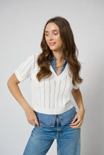 Load image into Gallery viewer, Woman wearing a white knitted and denim collared and hem short sleeve top and blue jeans against a plain background.
