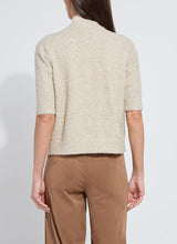 Load image into Gallery viewer, Model wearing a feather yarn, gold lurex knitted cardigan and brown pants against a white background.
